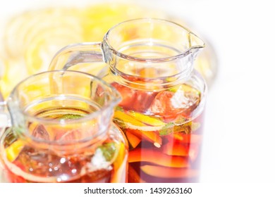 Two Pither Jugs With Traditional British Summer Pimms Cocktail Punch With Lemonade, Strawberries, Cucumber, Orange And Mint Isolated. Garden Party Or Catering Concept With Copy Space