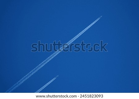 two planes in the sky, two parallel airplane tracks in the blue sky, contrails