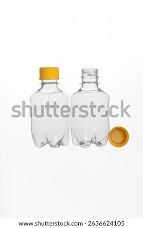 Two plastic bottles with a yellow cap