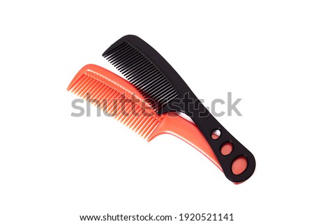 Two plastic combs isolated on a white background