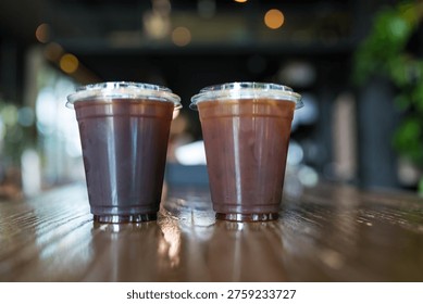 Dos tazas de plástico de cerveza fría americano en la mesa de madera