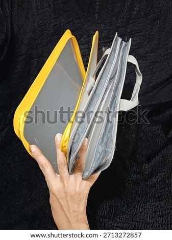 two plastic folders that cannot be used because the zipper is damaged and torn in several places