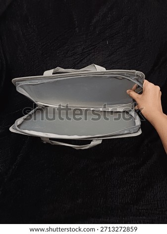 two plastic folders that cannot be used because the zipper is damaged and torn in several places