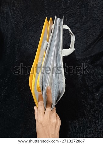 two plastic folders that cannot be used because the zipper is damaged and torn in several places