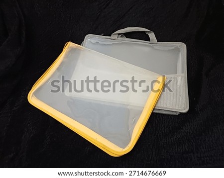 two plastic folders that cannot be used because the zipper is damaged and torn in several places