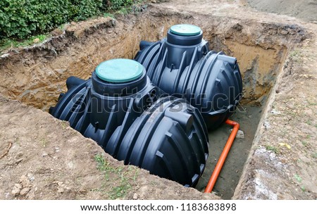 Two plastic underground storage tanks placed below ground for harvesting rainwater. The underground water septic tanks, for use as ecological recycling rainwater. Tank for home water harvest.