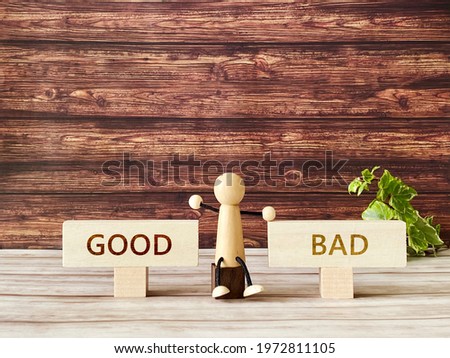 Two plates with Good bad letters and a wooden doll