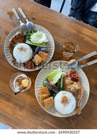 two plates that deserve different tipe of chicken cuisine, one of the is fried and the oher one is grilled.