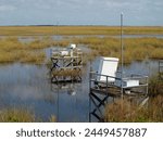 Two platforms with hydrologic equipment in the wet plains of the Everglades, Florida. 