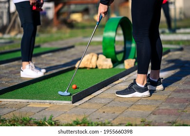 Two players playing minigolf on the loop lane. 