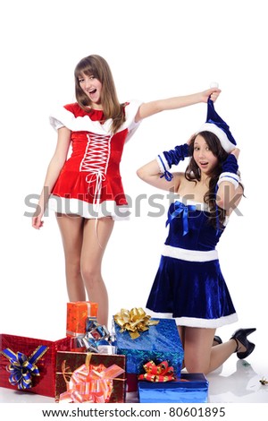 two playful girls in christmas clothing, isolated on white