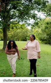 Two Plus Size Black Friends Walking And Hanging Out At The Park