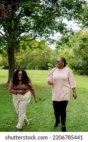 Two Plus Size Black Friends Walking And Hanging Out At The Park