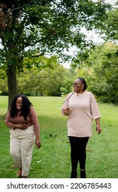 Two Plus Size Black Friends Walking And Hanging Out At The Park