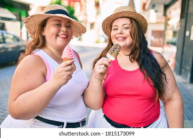 Two Plus Size Overweight Sisters Twins Women Smiling Eating An Ice Cream Outdoors