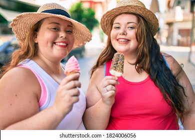 Two Plus Size Overweight Sisters Twins Women Smiling Eating An Ice Cream Outdoors