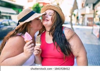 Two Plus Size Overweight Sisters Twins Women Smiling Eating An Ice Cream Outdoors