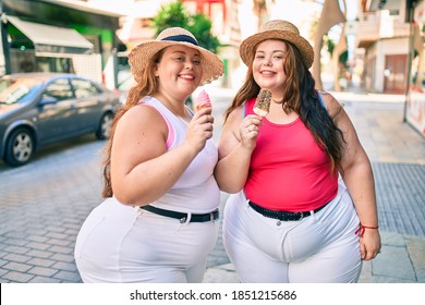 Two Plus Size Overweight Sisters Twins Women Smiling Eating An Ice Cream Outdoors