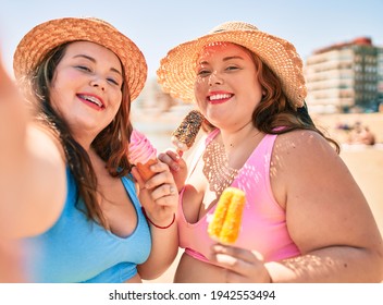 Two Plus Size Overweight Sisters Twins Women Eating Sweet Ice Cream At The Beach On Summer Holidays