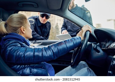 Two Police Officers Talking With Female Driver