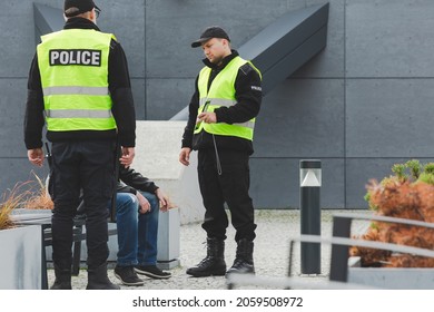 Two Police Officers Talking To Man On The Street