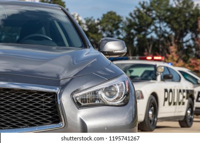 Two Police Vehicles Stop A Sedan On A Routine Traffic Stop