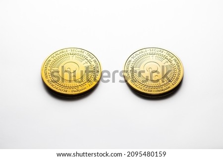 Two Polkadot golden coins photographed on a white background, as a product shooting 