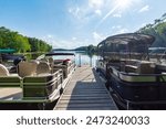 Two pontoon boat flank each side of a boat pier on a lake in northern Wisconsin.