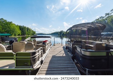 Two pontoon boat flank each side of a boat pier on a lake in northern Wisconsin.