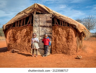 Two Poor African Children In Front Of A Hut In An African Village