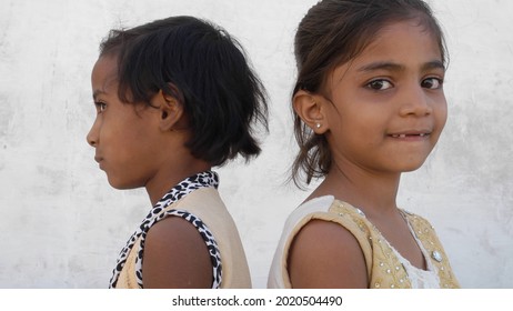 Two poor Indian children standing next to each other