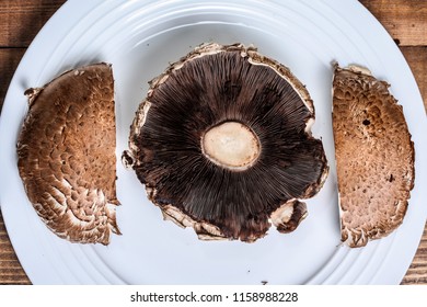 Two Portabella Mushroom Caps On White Plate