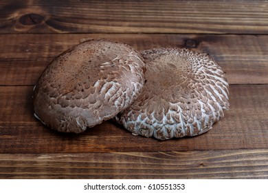 Two Portabella Mushroom Caps On Wooden Boards