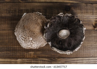 Two Portabella Mushroom Caps On Wooden Boards