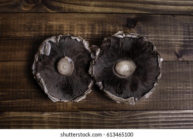 Two Portabella Mushroom Caps On Wooden Boards