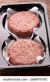 Two Portion Of Minced Meat Analogue For Vegetarian Burgers In Plastic Box On Wooden Table