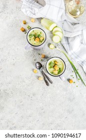 Two Portions Of Homemade Zucchini Creamy Soup With Bread Crumbs In Mugs On A Light Concrete Background. Above