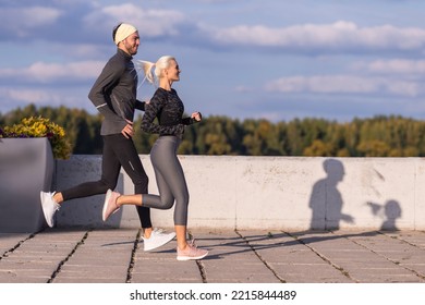 Two Positive Caucasian Runners Athletes Training Together During Running Training Fitness Exercise At Nature Outside As Runners During Training Outdoor Process. Horizontal Image Orientation