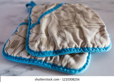 Two Pot Holder Or Oven Cloth On A White Marble Plate In Kitchen