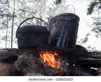 Two Pots Over A Fire In A Stone Hearth