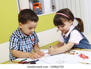 Two Preschool Children Playing With Crayons