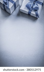 Two present boxes on blue background copyspace holidays concept.