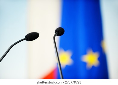 Two Press Conference Microphones With The European Union Flag In The Background