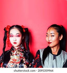 Two Pretty Geisha Friends: Modern Asian Woman And Traditional Wearing Kimono Posing Cheerful On Red Background