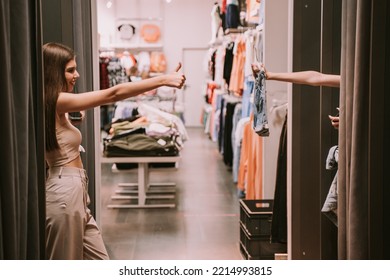 Two Pretty Girls In The Changeing Room. One Of Them Showing The Shorts And The Other One Liking Them