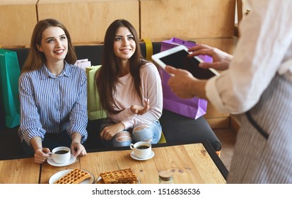 Two Pretty Girls Flirting With Waiter In Cafe, Digital Tablet With Black Blank Screen