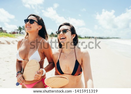 Two pretty girls having fun on tropical beach