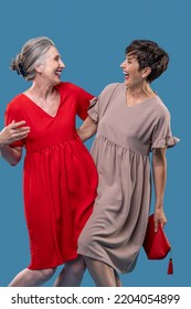 Two Pretty Mature Women In Dresses Looking Happy