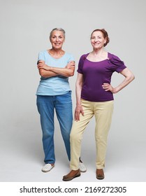 Two Pretty Older Women Friends On Grey Background. Lifestyle Concept.