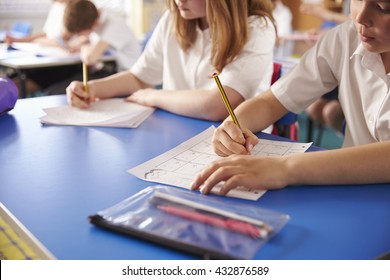 Two Primary School Kids Working In Class, Close Crop